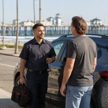 Auto locksmith assisting a driver locked out near the Oceanside Pier